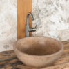 Round travertine sink Ball Scuro for the bathroom