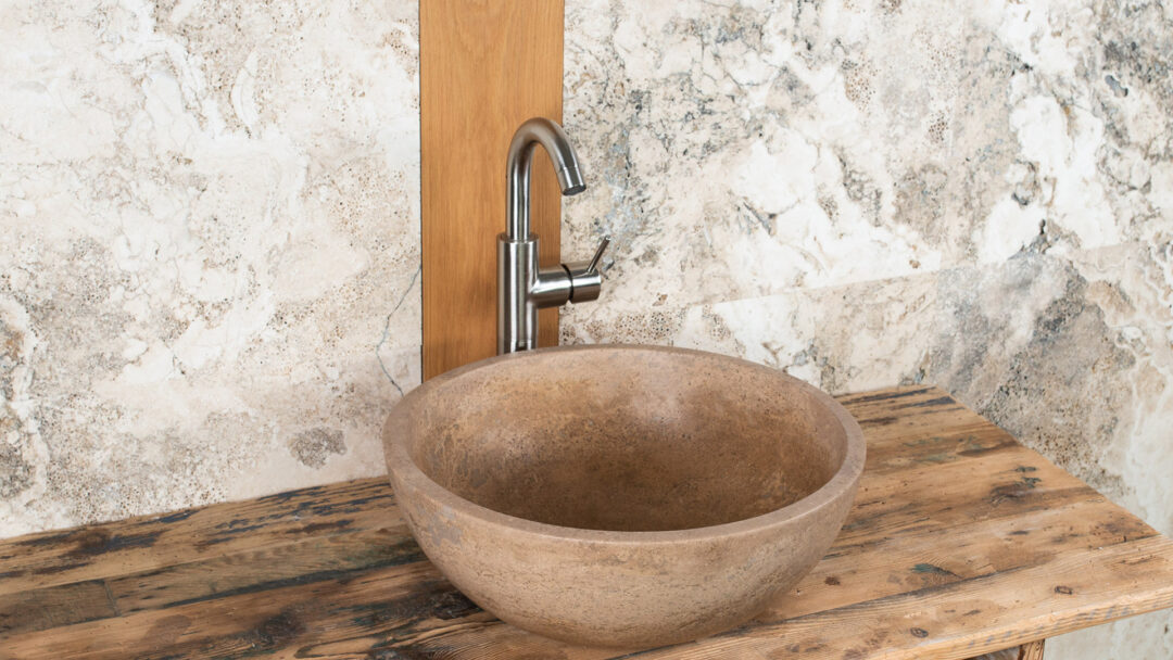 Round travertine sink Ball Scuro for the bathroom