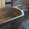 Gray travertine bathtub