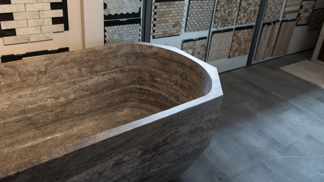 Gray travertine bathtub