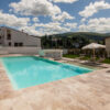 Esterno piscina in travertino Leather Brown in un resort in campagna