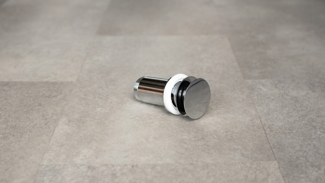 Piletta in acciaio inox modello click-clack per lavabi in travertino