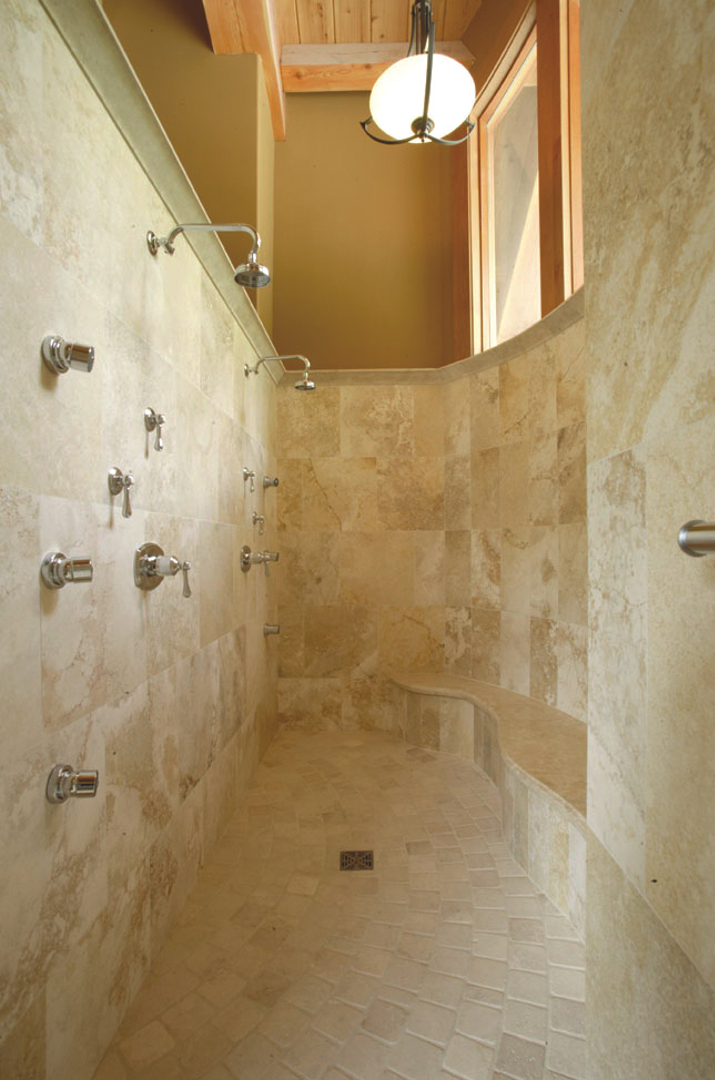 Shower clad in golden yellow travertine "Nuvolato Gold"