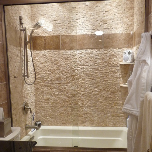 bathroom with travertine mosaic coverings